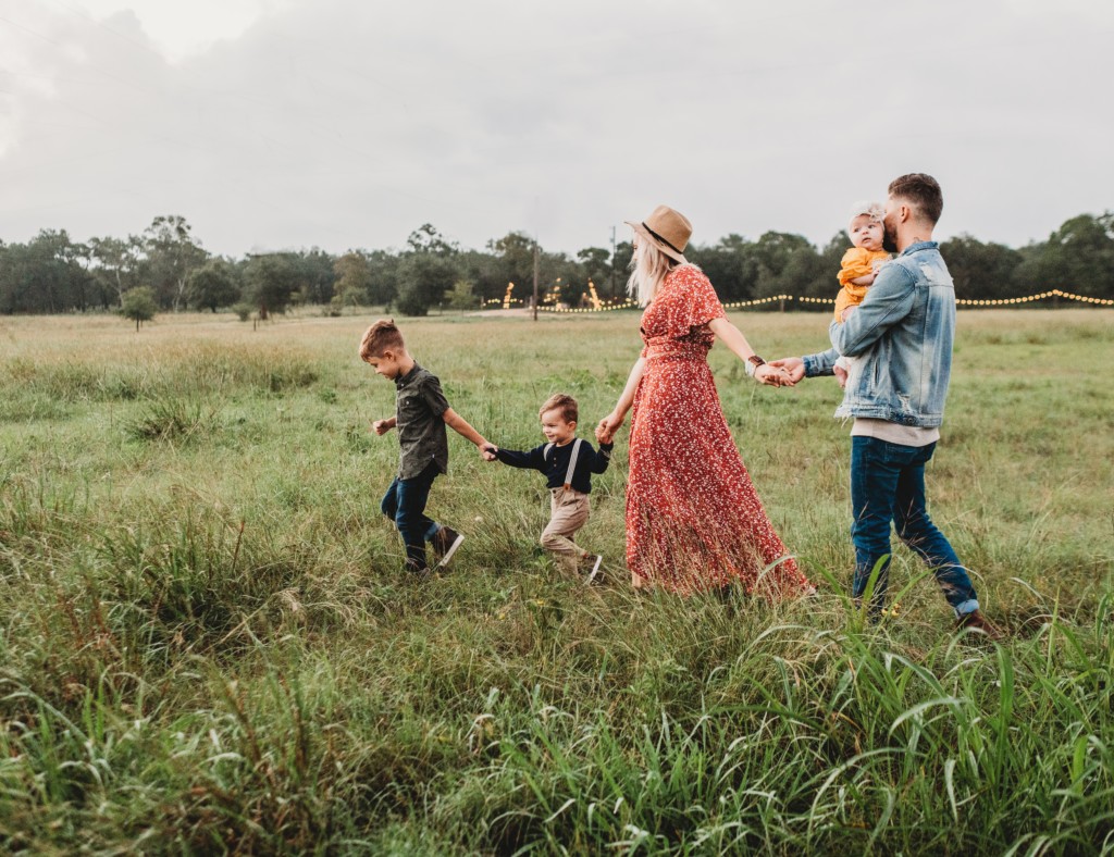 family of 5 walking through field, new moms