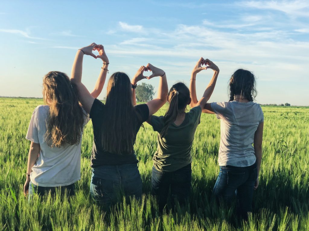 four teens in a field