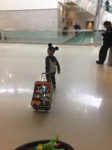 Child in an airport with luggage