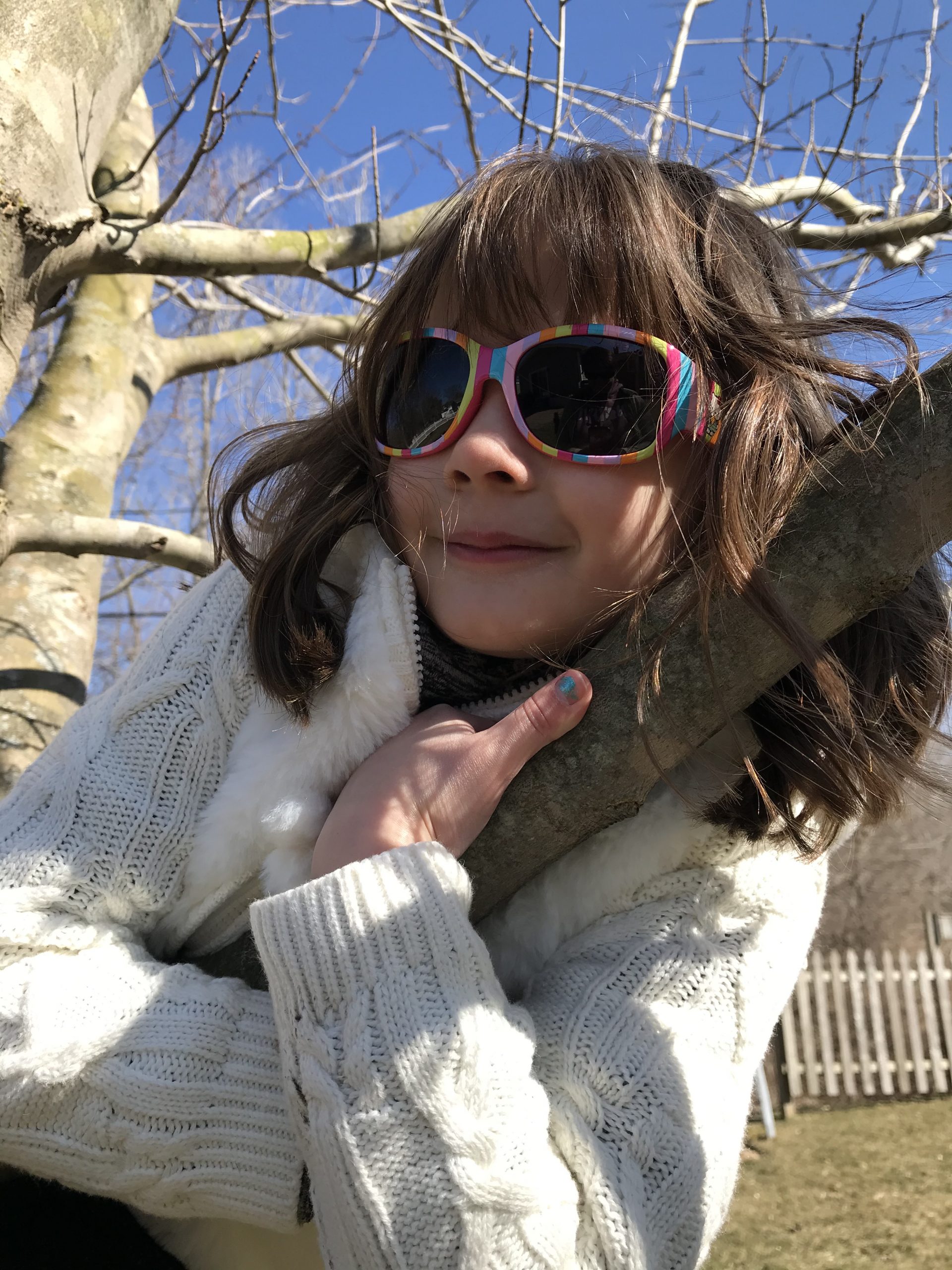 girl climbing a tree, early spring, sunny