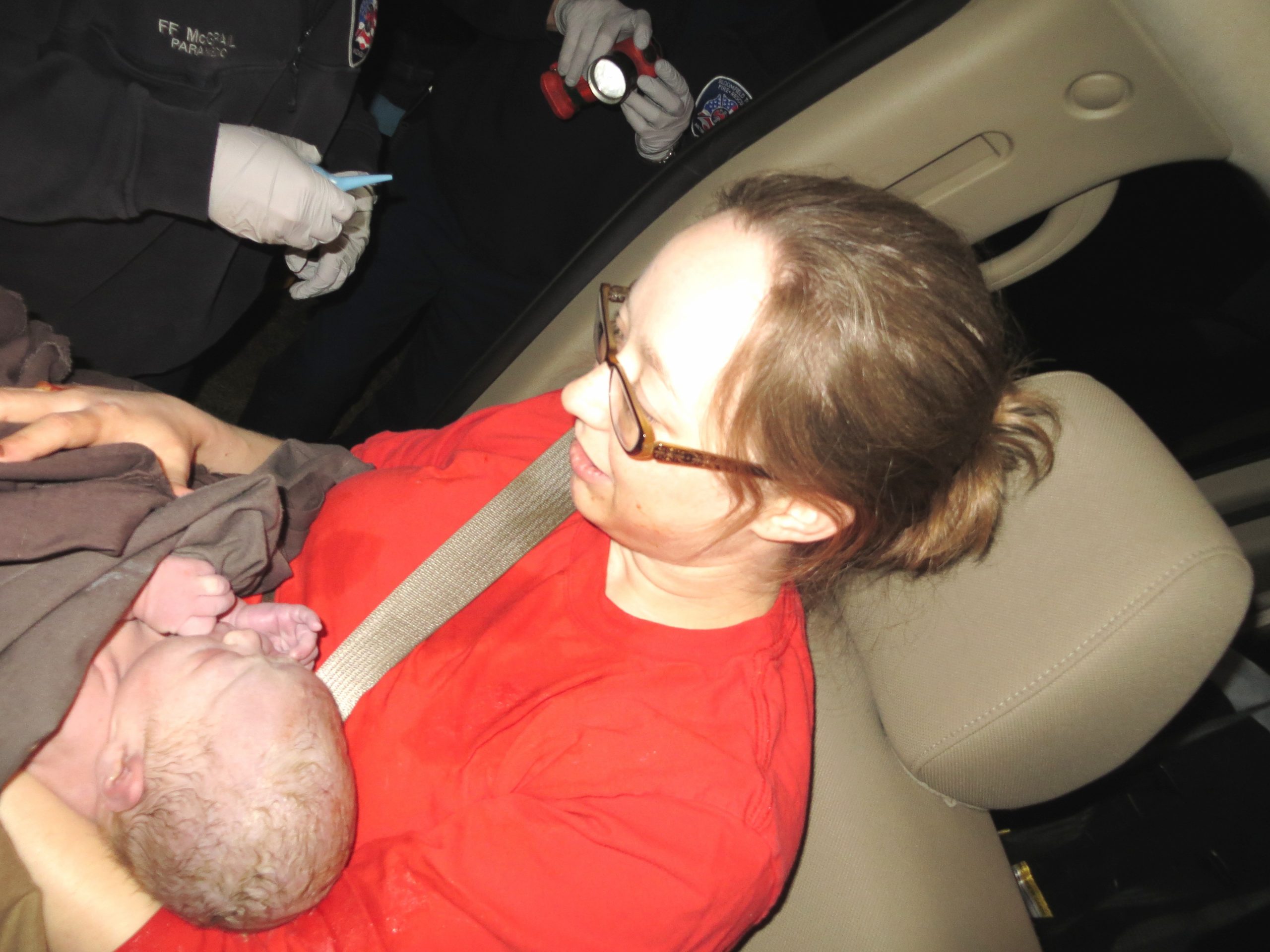 mother after roadside delivery, paramedics present