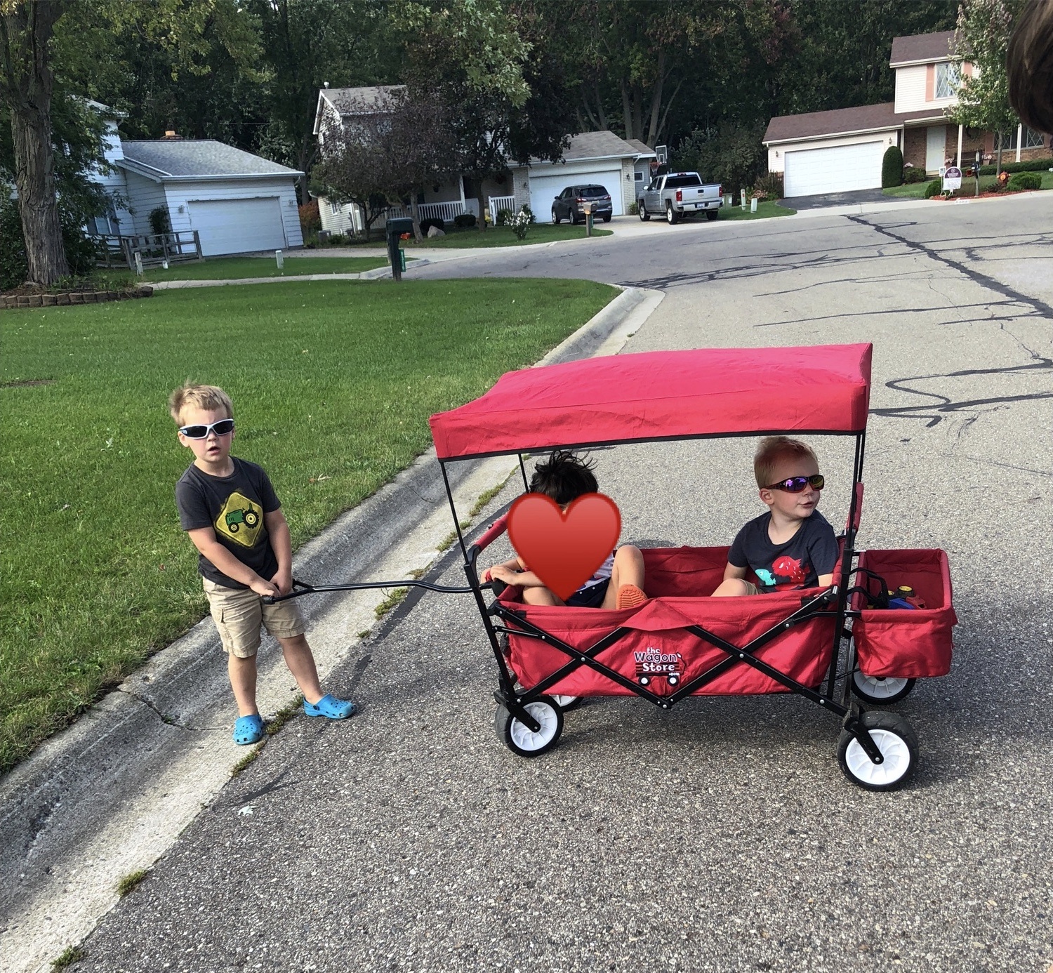 Kids playing in a cul-de-sac in a wagon