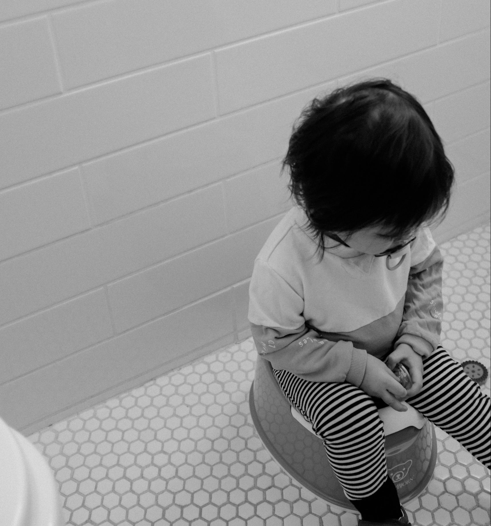 child sitting on potty chair