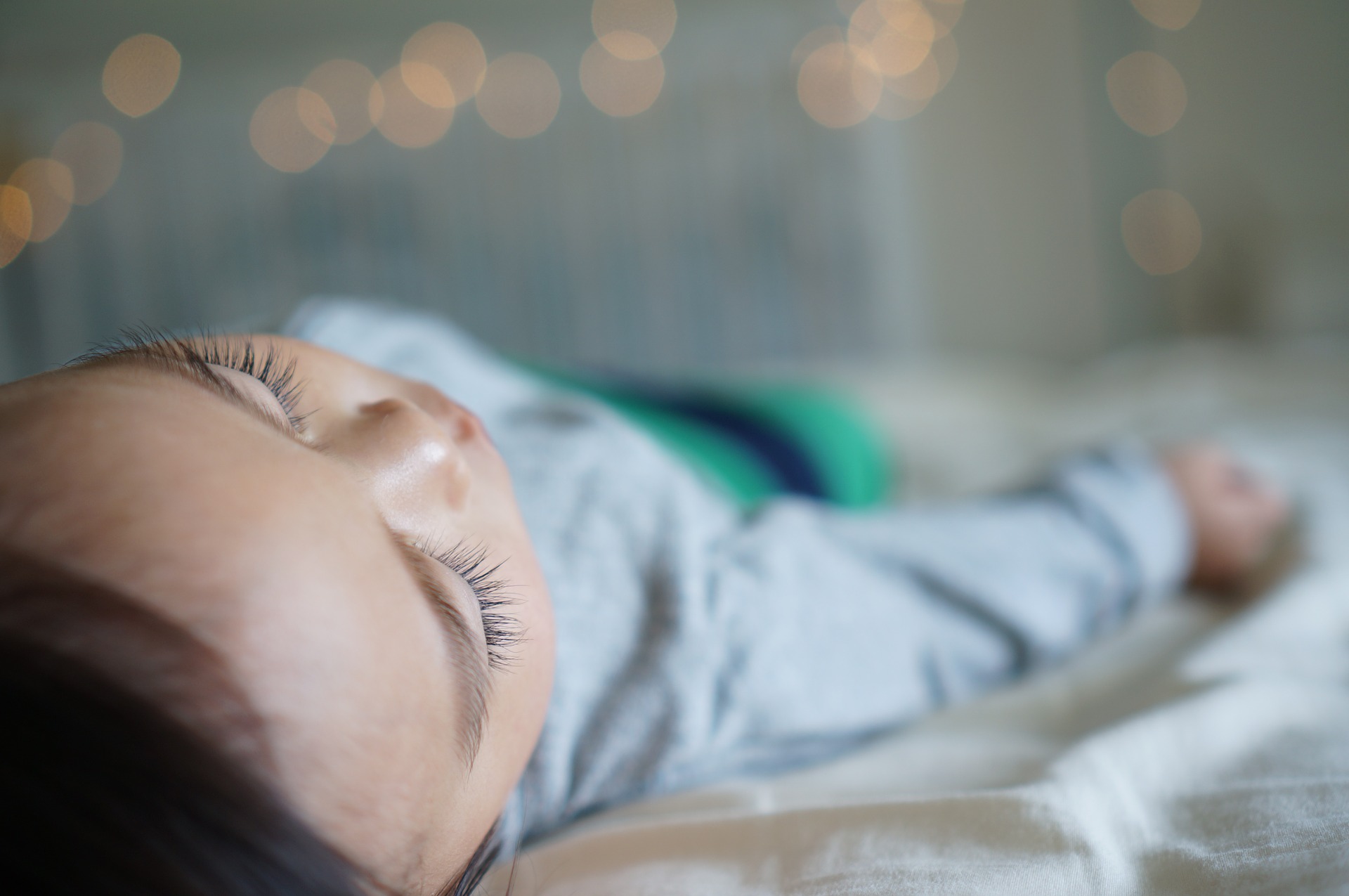 baby sleeping in a crib, close up 